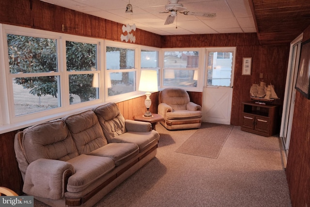 sunroom with a paneled ceiling and ceiling fan