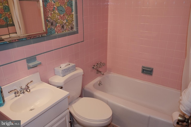 full bathroom with vanity, shower / bath combination with curtain, toilet, and tile walls