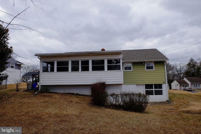 back of property with a lawn