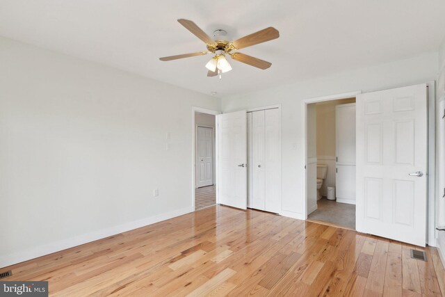 12106 Preston Dr, Lusby, MD 20657 - unfurnished bedroom featuring visible vents, a closet, wood finished floors, baseboards, and a ceiling fan