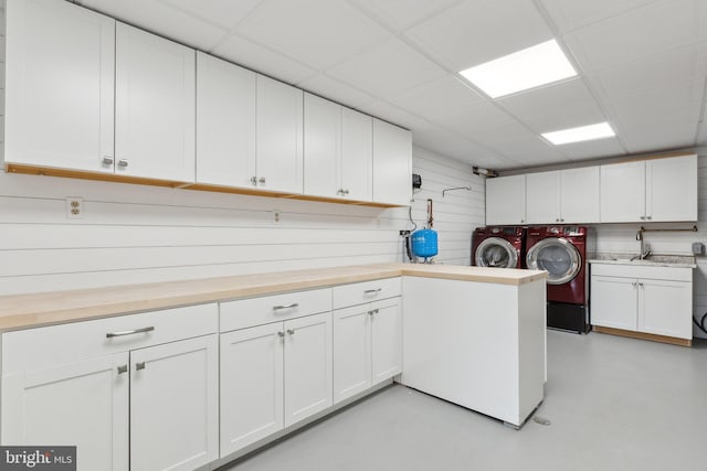 12106 Preston Dr, Lusby, MD 20657 - clothes washing area featuring a sink, cabinet space, and washing machine and clothes dryer