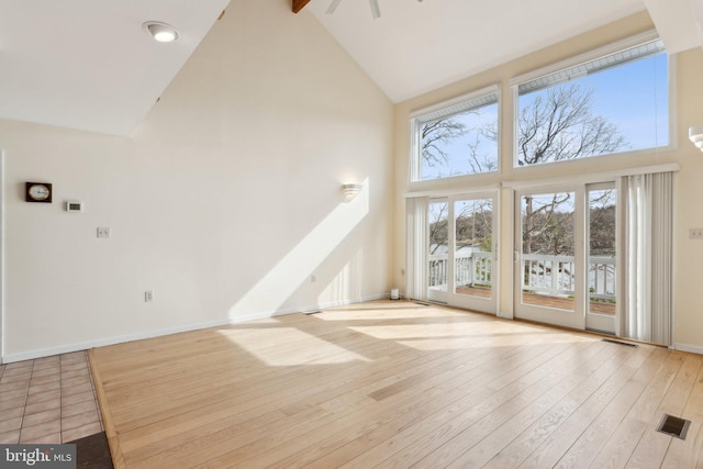 12106 Preston Dr, Lusby, MD 20657 - unfurnished living room with high vaulted ceiling, baseboards, hardwood / wood-style flooring, and visible vents