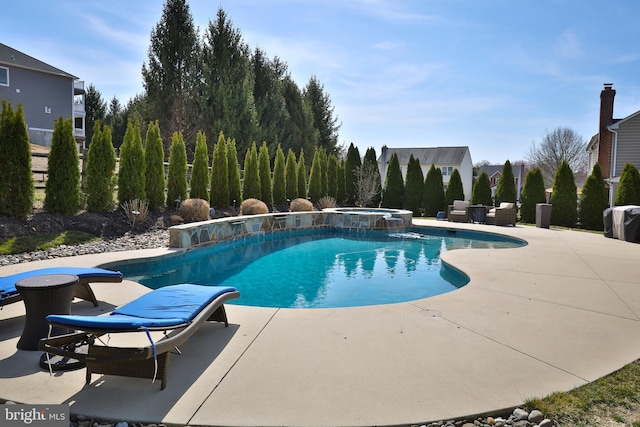 view of pool featuring a pool with connected hot tub and a patio area