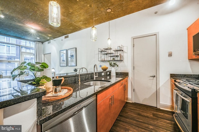 kitchen featuring dark stone counters, a sink, visible vents, appliances with stainless steel finishes, and dark wood-style floors