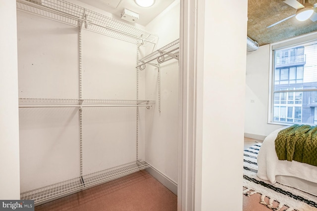 spacious closet with ceiling fan