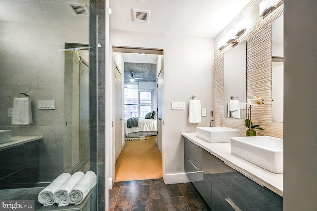 ensuite bathroom featuring a shower stall, connected bathroom, visible vents, and a sink