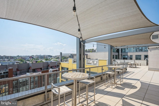 view of patio with a city view and a balcony