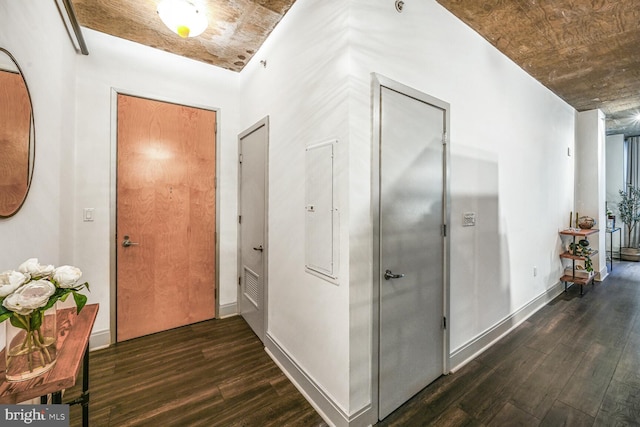 corridor with visible vents, baseboards, and wood finished floors