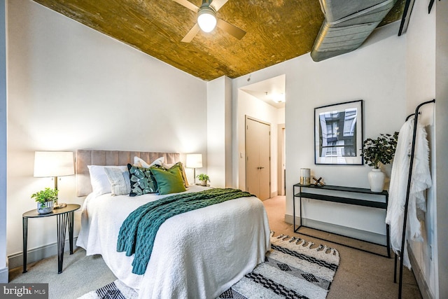 bedroom featuring carpet floors, wooden ceiling, baseboards, and vaulted ceiling