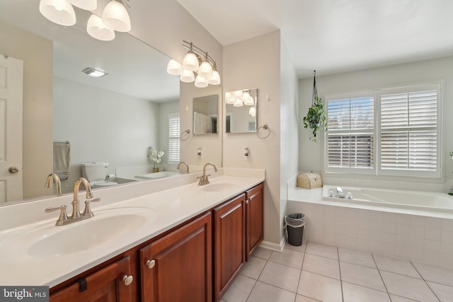 full bath featuring tile patterned floors, double vanity, a bath, and a sink