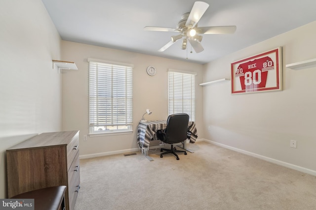 carpeted office with visible vents, baseboards, and ceiling fan