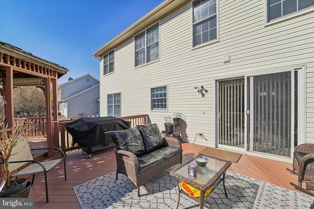 wooden terrace featuring area for grilling and outdoor lounge area