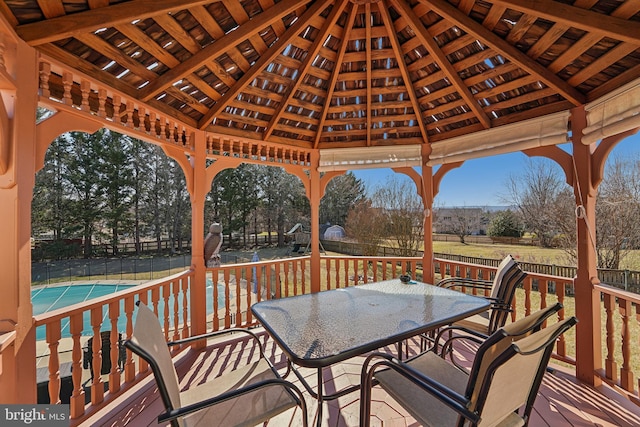 deck with a gazebo, outdoor dining area, and fence