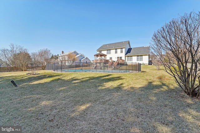 view of yard with a fenced in pool and fence