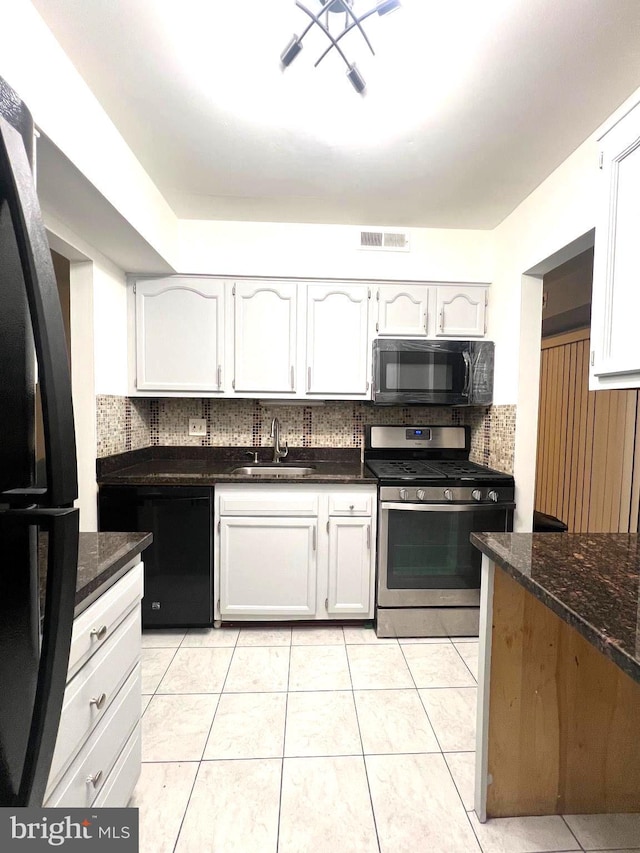 kitchen with a sink, white cabinetry, visible vents, decorative backsplash, and black appliances