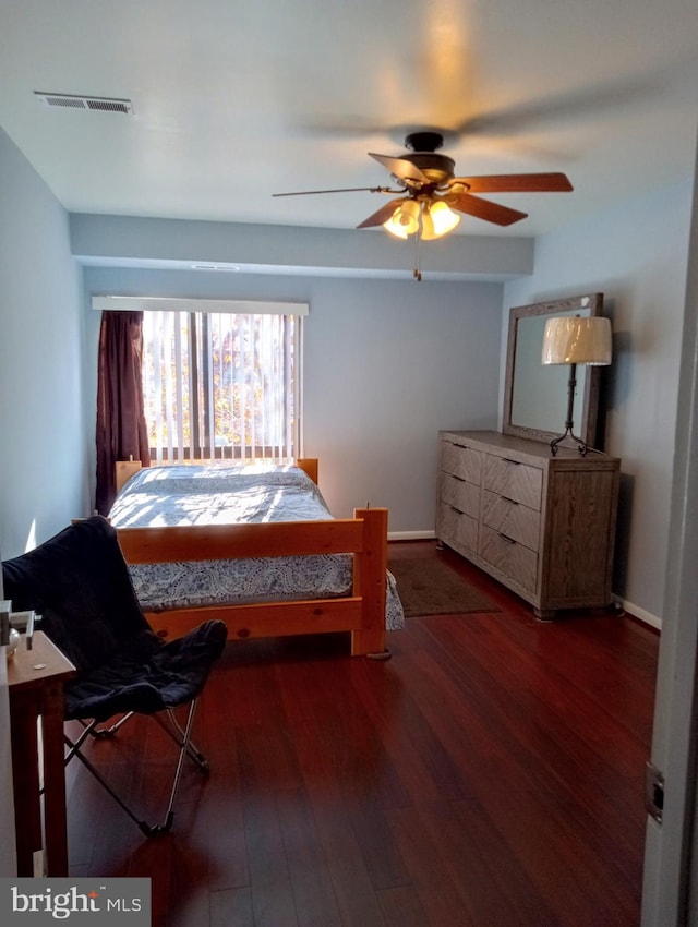 bedroom with visible vents, ceiling fan, baseboards, and wood finished floors