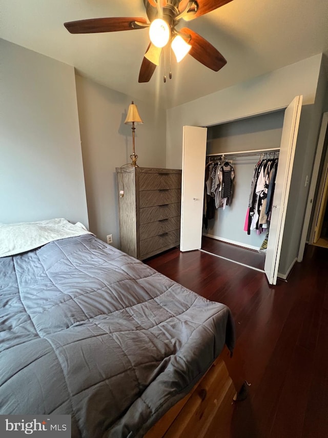 bedroom featuring a closet, ceiling fan, baseboards, and wood finished floors