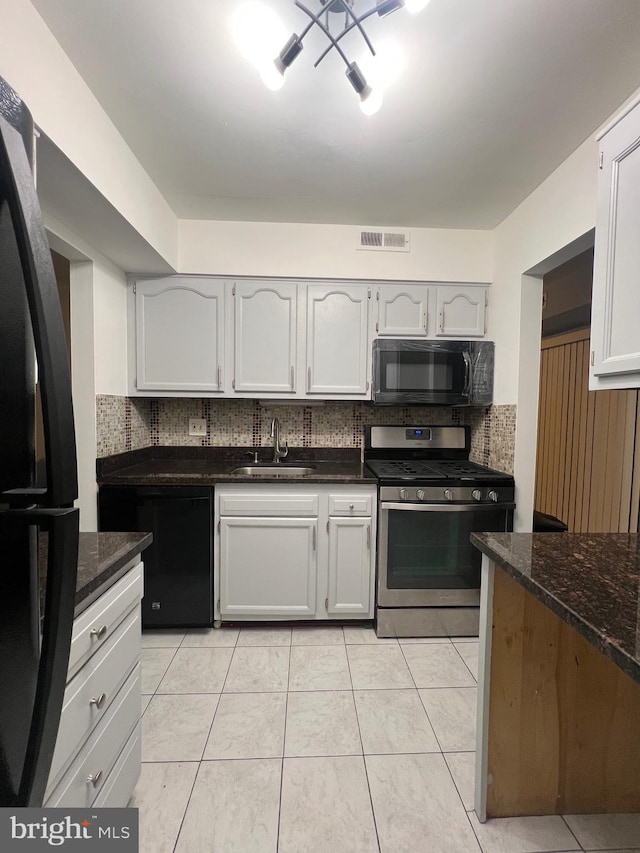 kitchen featuring visible vents, a sink, black appliances, backsplash, and light tile patterned flooring