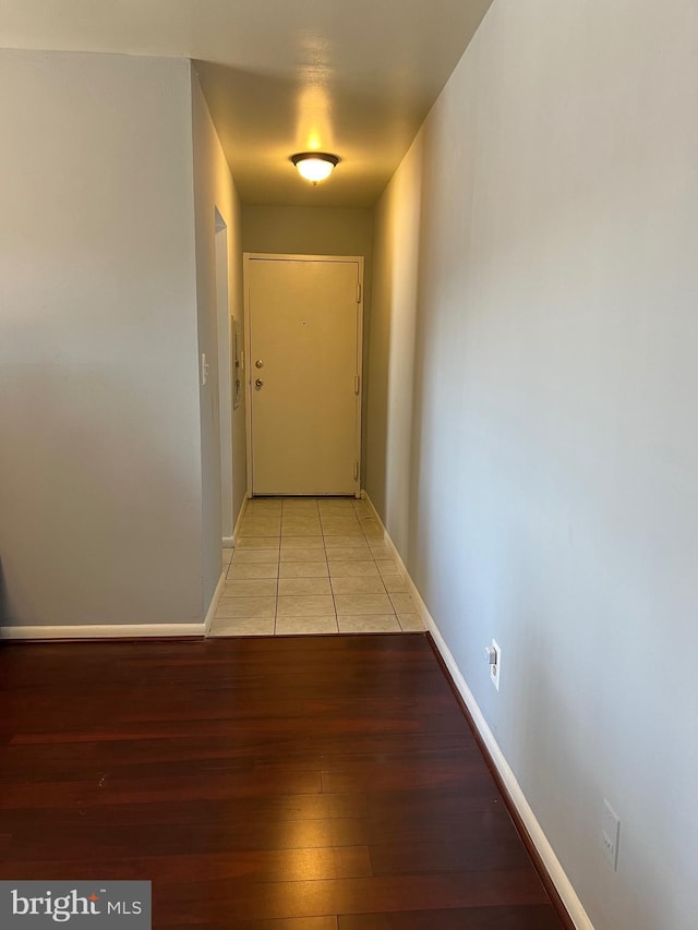 hall featuring baseboards and light wood finished floors