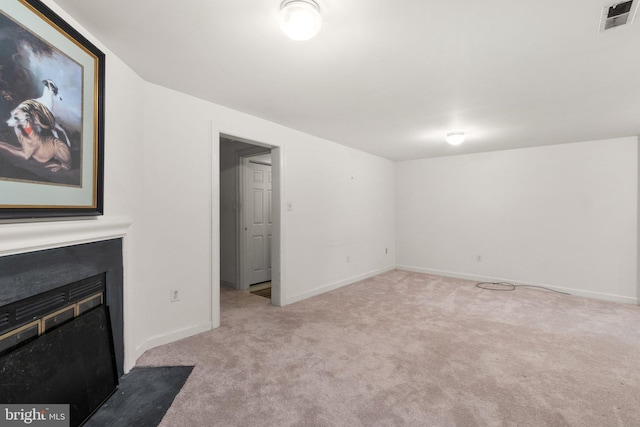 unfurnished living room featuring carpet floors, baseboards, and visible vents