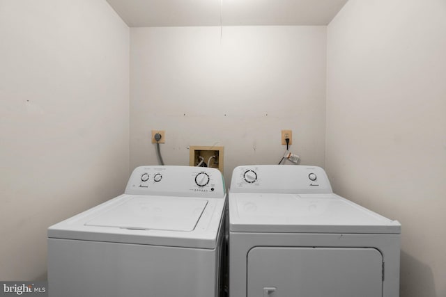 clothes washing area with laundry area and washer and dryer