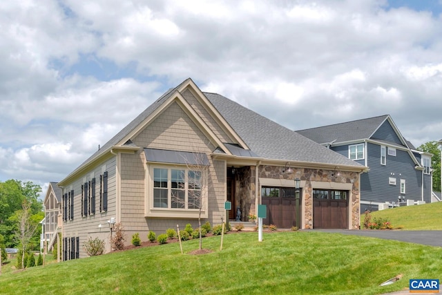 craftsman house featuring a garage, stone siding, aphalt driveway, a standing seam roof, and a front yard