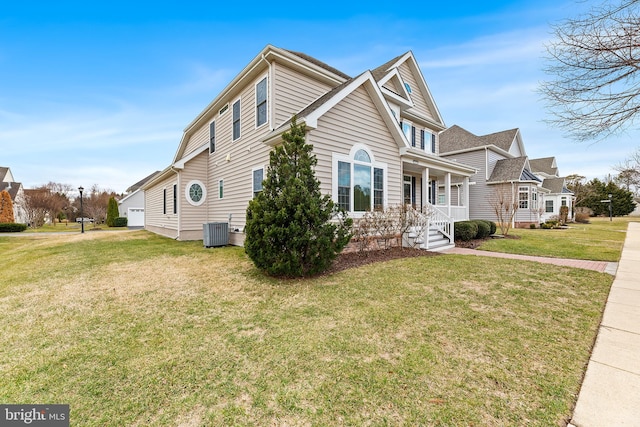 view of front of home with cooling unit and a front yard