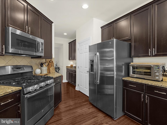 8512 Pine Springs Dr, Severn, MD 21144 - kitchen featuring appliances with stainless steel finishes, dark wood-style flooring, light stone countertops, dark brown cabinetry, and recessed lighting