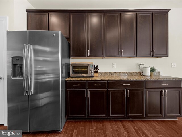 8512 Pine Springs Dr, Severn, MD 21144 - kitchen featuring stainless steel refrigerator with ice dispenser, light stone counters, dark brown cabinets, and dark wood finished floors