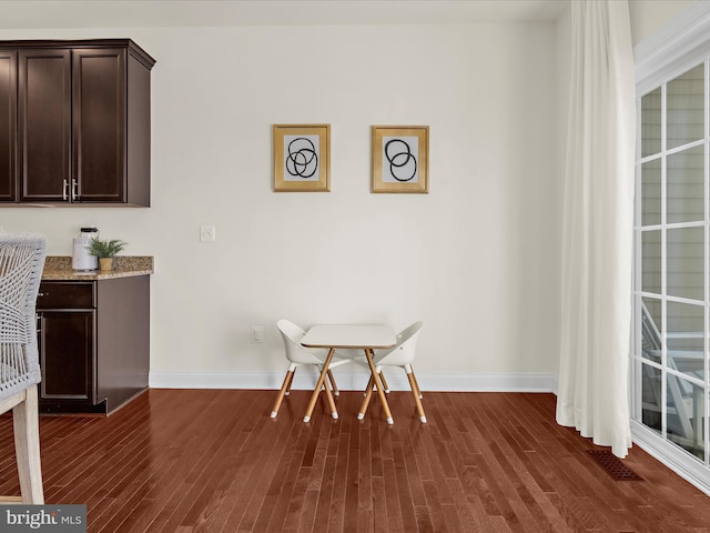 8512 Pine Springs Dr, Severn, MD 21144 - dining area featuring dark wood-style floors and baseboards