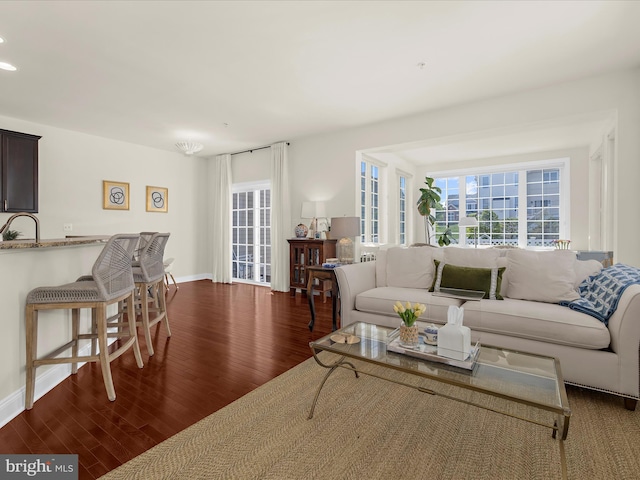 8512 Pine Springs Dr, Severn, MD 21144 - living area with wood finished floors, plenty of natural light, and baseboards