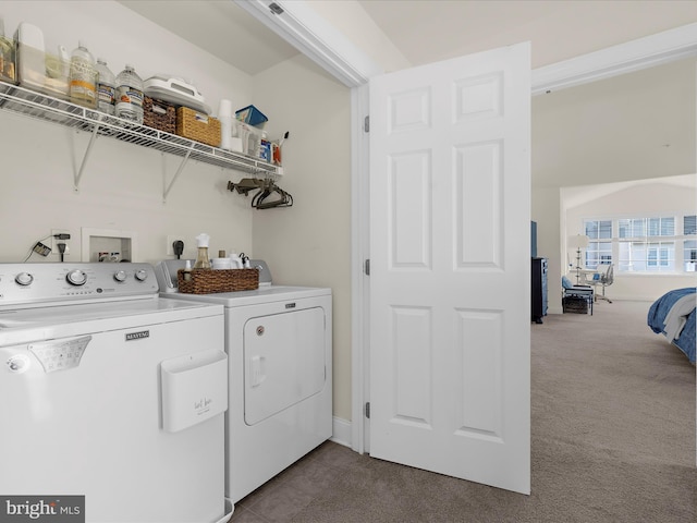 8512 Pine Springs Dr, Severn, MD 21144 - washroom with washer and clothes dryer, dark carpet, and dark tile patterned flooring