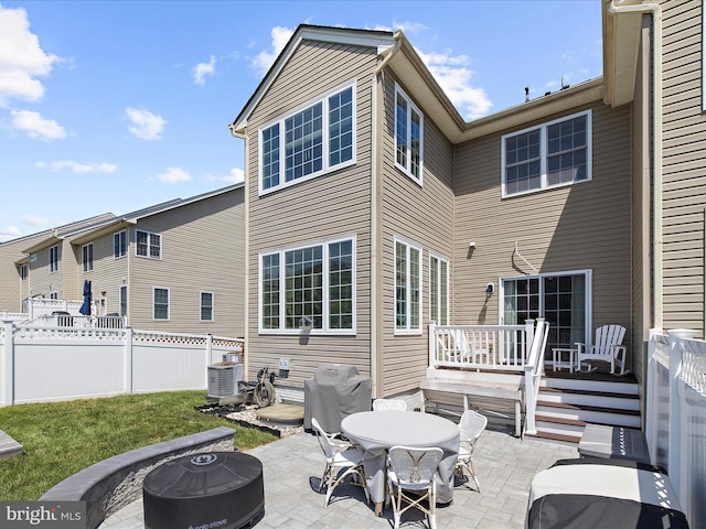 8512 Pine Springs Dr, Severn, MD 21144 - back of house featuring a patio area, a fire pit, fence, and outdoor dining area