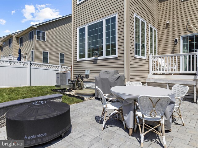 8512 Pine Springs Dr, Severn, MD 21144 - view of patio featuring fence, outdoor dining space, area for grilling, central AC unit, and a fire pit
