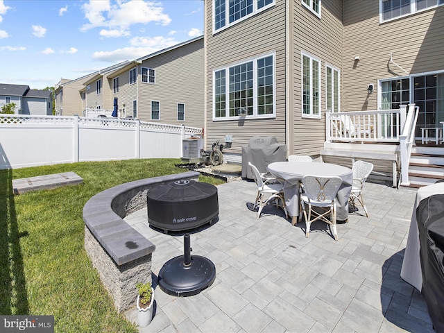 8512 Pine Springs Dr, Severn, MD 21144 - view of patio / terrace with a fire pit, outdoor dining area, cooling unit, and area for grilling