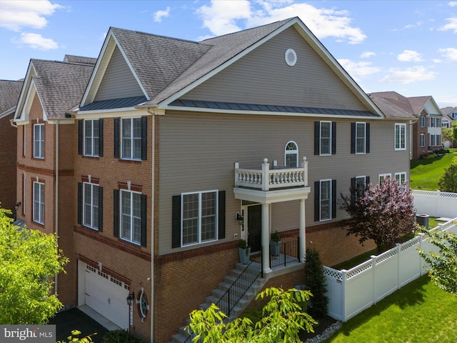 8512 Pine Springs Dr, Severn, MD 21144 - back of property featuring brick siding, fence, a balcony, and an attached garage