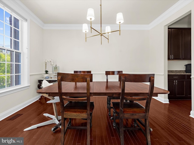 8512 Pine Springs Dr, Severn, MD 21144 - dining area with a chandelier, ornamental molding, dark wood finished floors, and baseboards