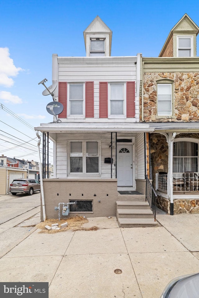 townhome / multi-family property with a porch