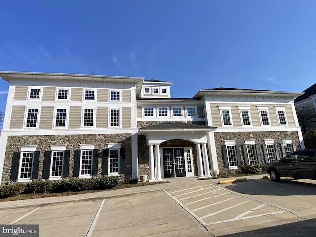 view of property featuring uncovered parking