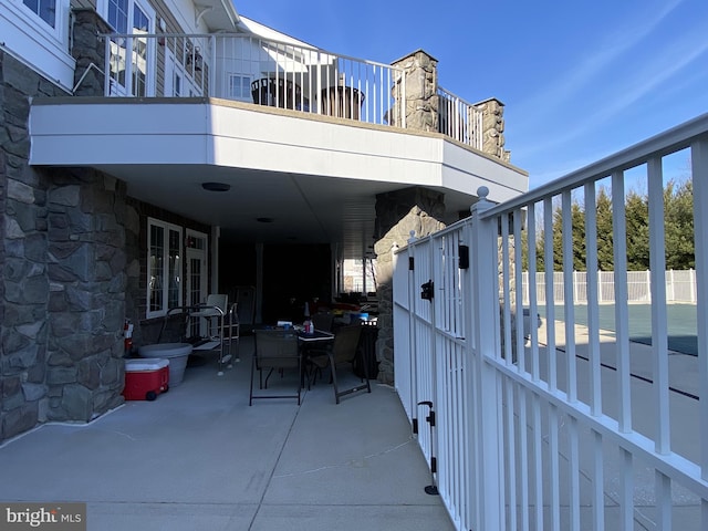 view of patio featuring outdoor dining space and fence