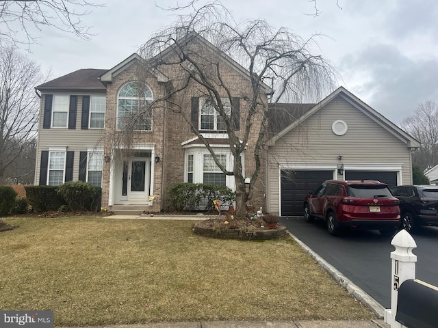 15 Eastwood Dr, East Windsor, NJ 08520 - colonial-style house with a front yard, brick siding, a garage, and driveway