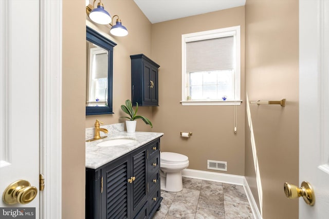 bathroom featuring vanity, toilet, baseboards, and visible vents