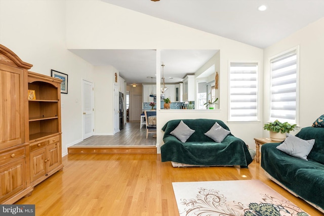 living room featuring recessed lighting, baseboards, light wood-style floors, and vaulted ceiling