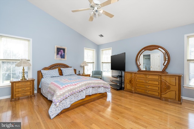 bedroom with visible vents, baseboards, light wood-style floors, high vaulted ceiling, and a ceiling fan