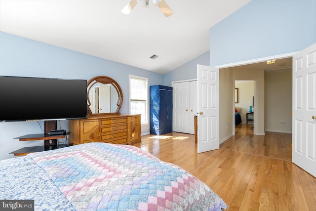 bedroom with visible vents, lofted ceiling, light wood-style floors, and baseboards