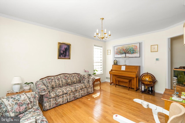 living area with baseboards, crown molding, an inviting chandelier, and wood finished floors