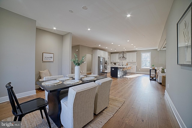 dining area featuring light wood-style floors, recessed lighting, and baseboards