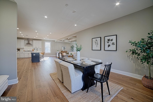 dining space with light wood-style floors and baseboards