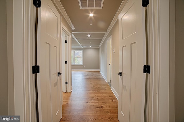 hallway with recessed lighting, visible vents, baseboards, ornamental molding, and light wood finished floors