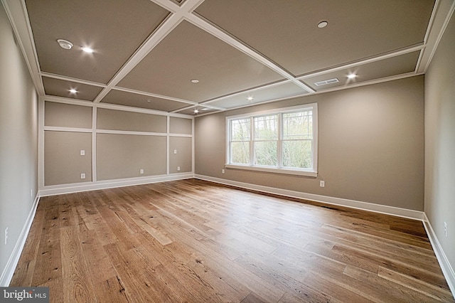 spare room with baseboards, visible vents, coffered ceiling, and wood finished floors